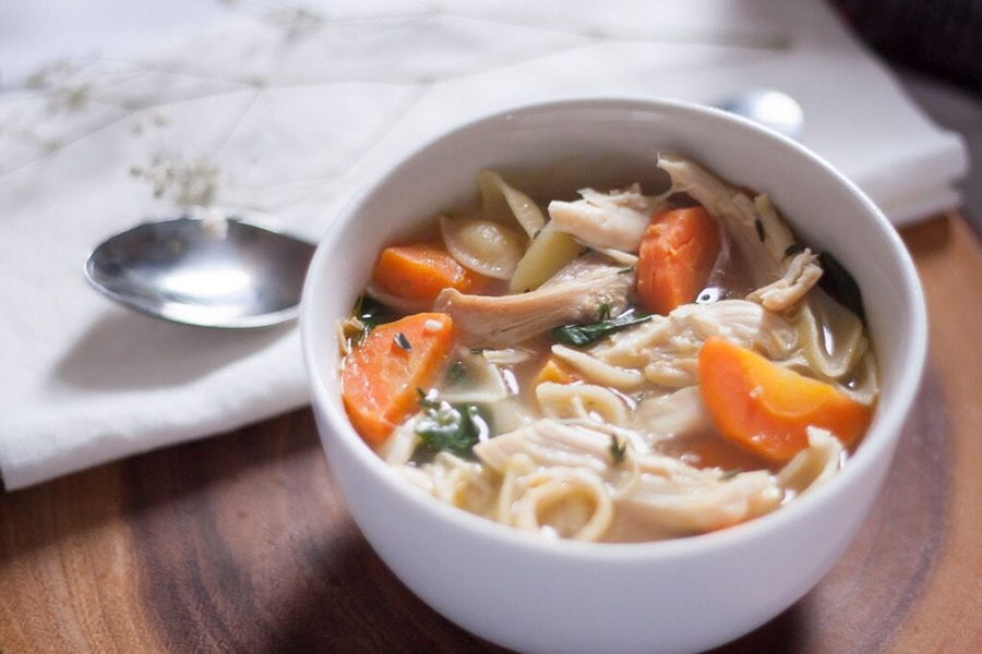 Chicken noodle soup and vegetables in bowl with Cook's Delight organic non-gmo chicken soup base
