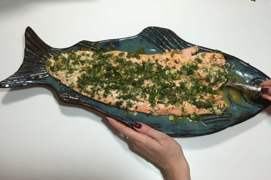 Salmon and herbs on a fish platter flavored with Cook's Delight Roasted Garlic Concentrate soup base
